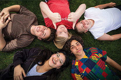 Several kids laying down on grass. Link to Kevin Marrazzo ’74 & Bunky Runser ’74's story.