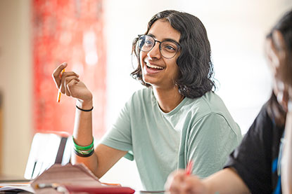 A student answering a question during class. Links to Gifts of Real Estate