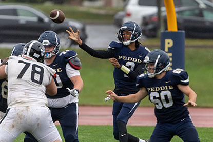 Students playing football. Links to Tangible Personal Property