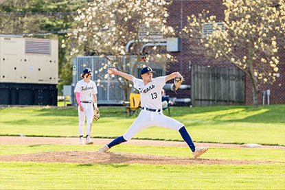 A student pitching a baseball. Links to Gifts of Appreciated Securities
